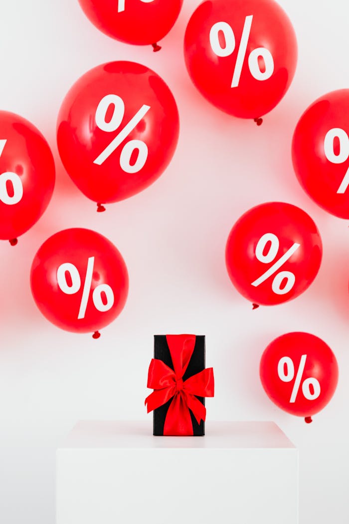 Red percentage balloons with gift box, ideal for sales promotions.